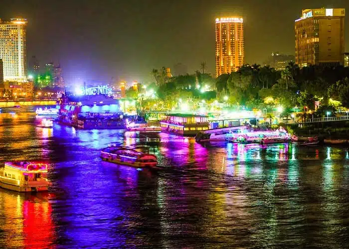 A-wonderful-view-of-Cairo-at-night,-showing-the-Nile-River-and-small-boats Cairo At Night