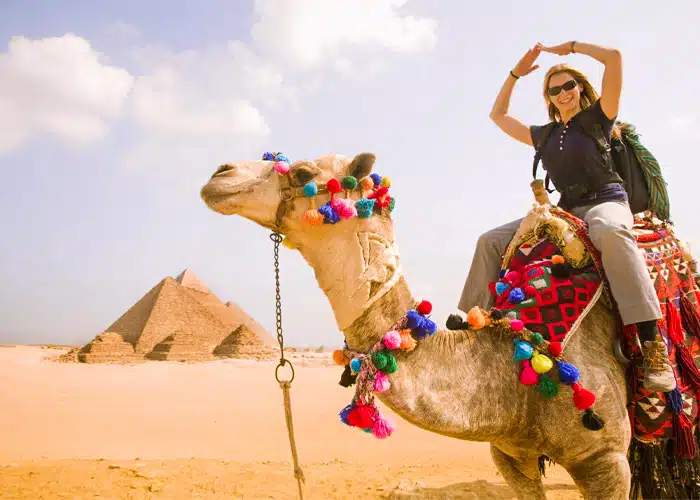 A-wonderful-view-of-a-female-tourist-riding-a-camel-in-front-of-the-pyramids-of-Giza